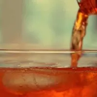 Liquor pouring into a cocktail glass