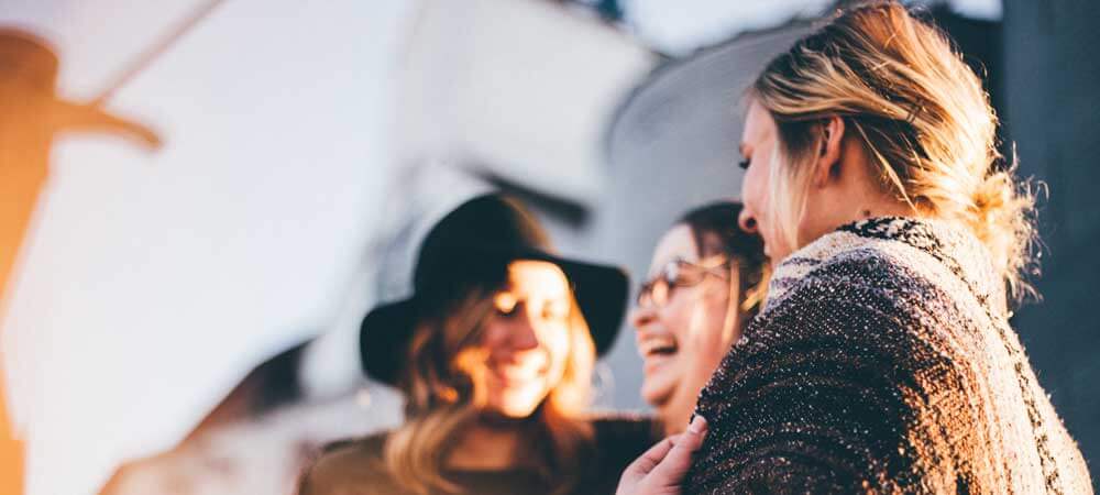 Photo of 3 women laughing.
