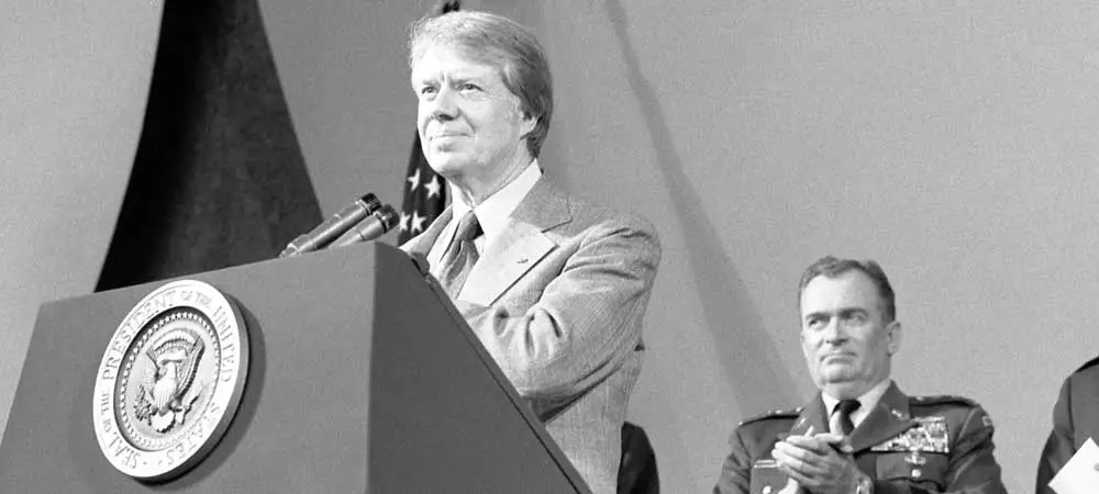 Photo of former US President Jimmy Carter speaking from the presidential podium.
