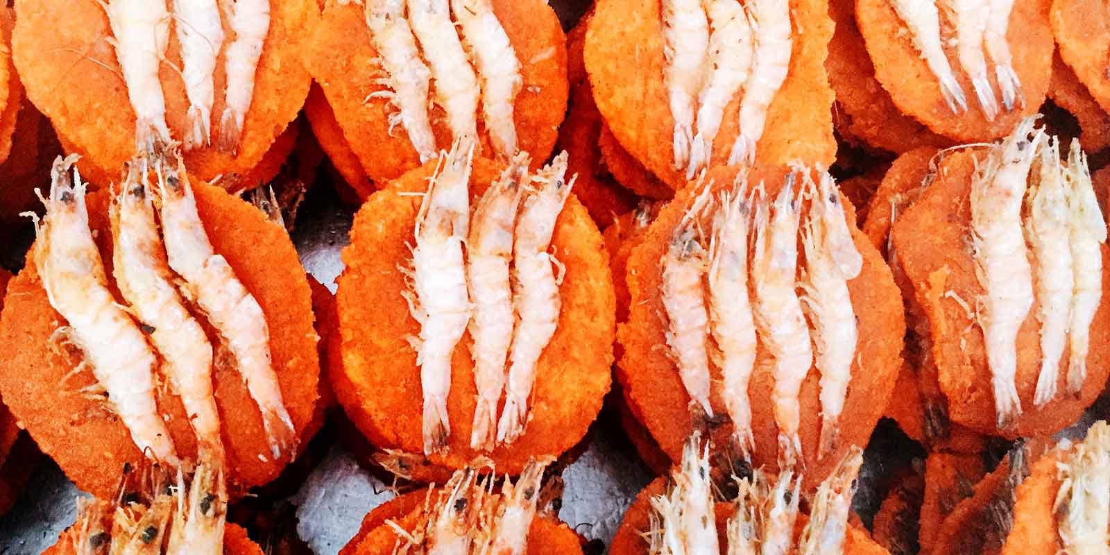 Get to know Colombo, Sri Lanka on a tuk tuk safari. You'll hear, see, smell, and taste all the city has to offer - like these brightly colored prawn cakes from a street food vendor at Galle Face.