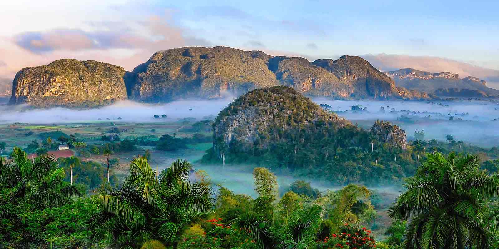 Now that you know the rules of visiting Cuba as an American, be sure to schedule a visit the Viñales Valley. This lush valley is one of 9 UNESCO World Heritage sites in Cuba.