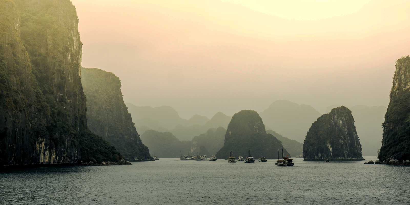 Marvel at the tall rock islands in Ha Long Bay in Vietnam.