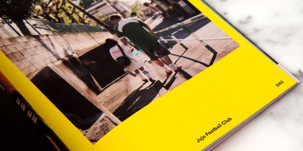 close up of a photo book showing a large photograph of 2 athletes