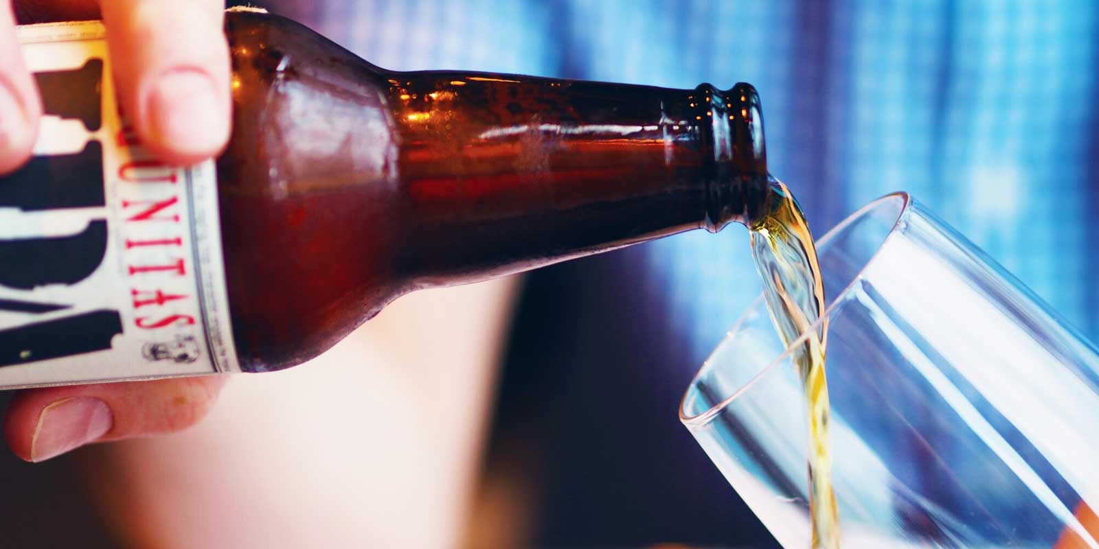 Photo of a bottle of Lagunitas IPA being poured into a glass