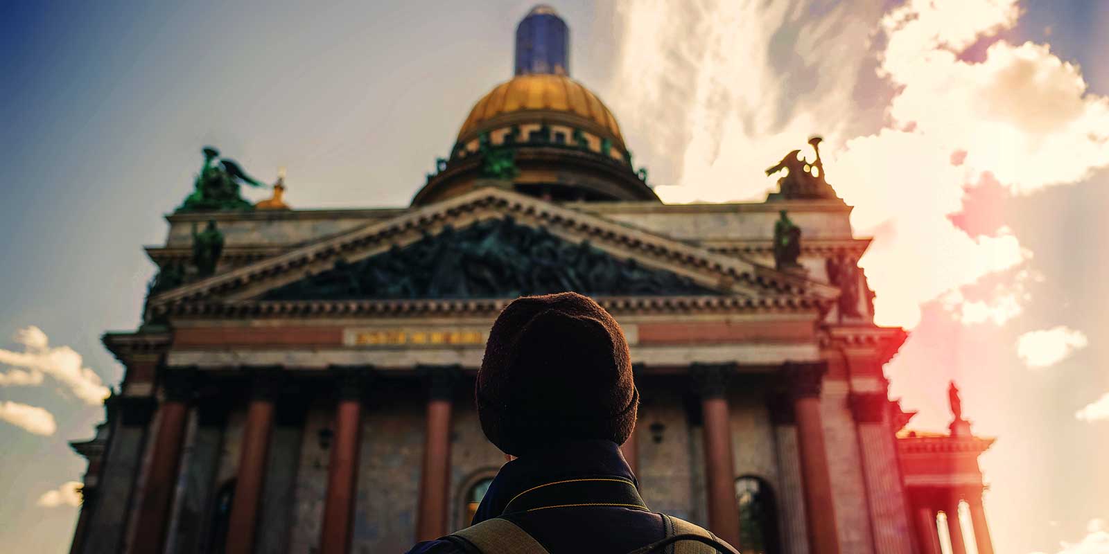Man looking up at an ornate building in St. Petersburg, Russia.