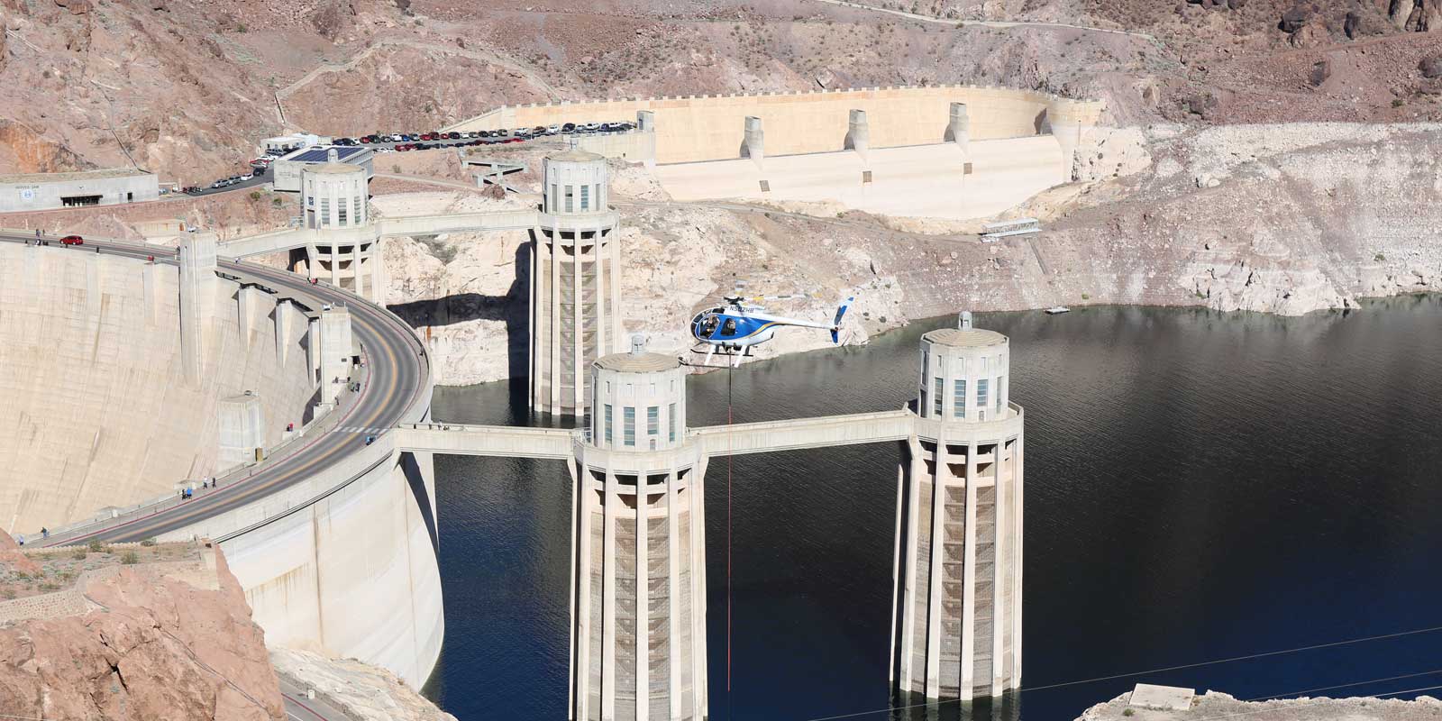 Photo of a helicopter hovering over the Hoover Dam Intake Tower Bridge.