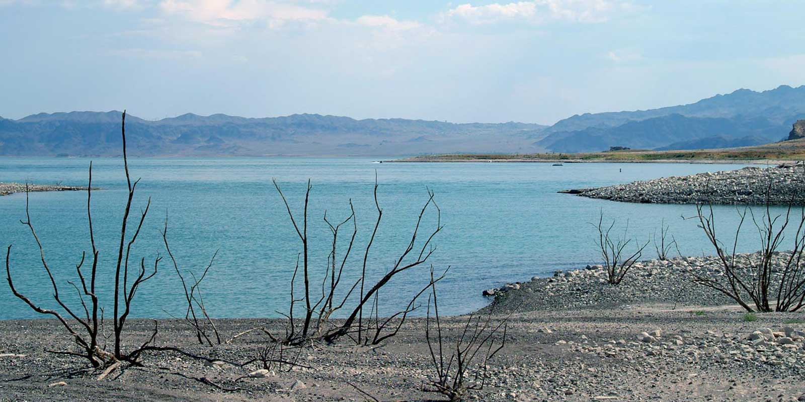 Landscape photo of the barren shoreline at Lake Mead during a drought.