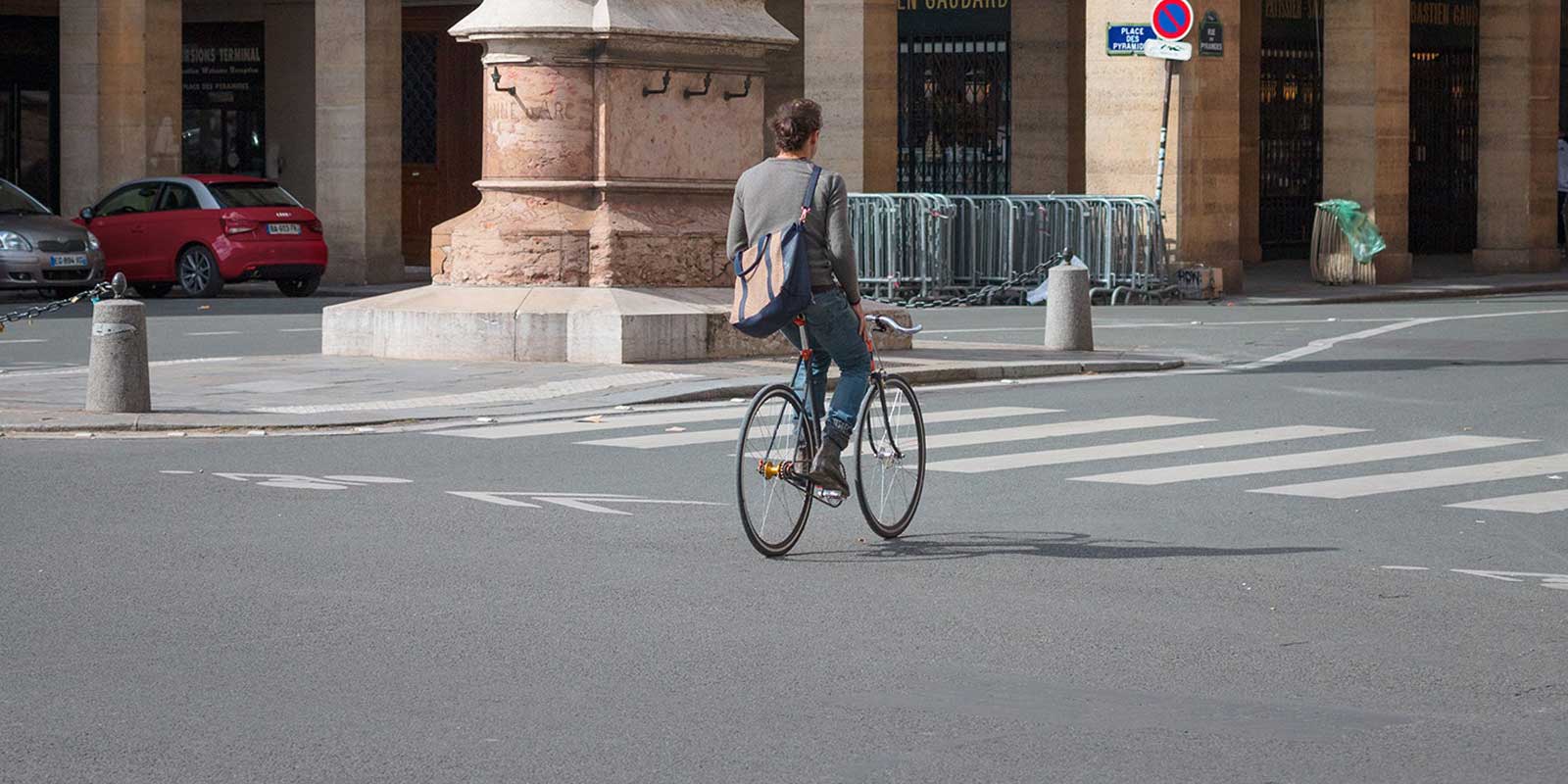 Man riding down the streets of Paris on a bicycle.