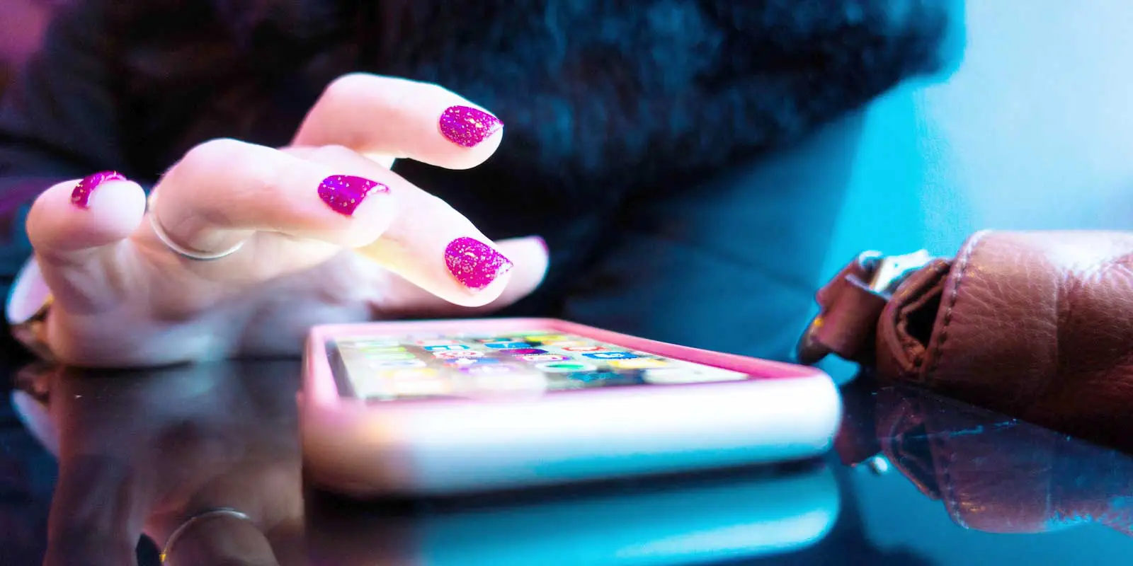 Closeup of a woman tapping an iPhone in a durable case.