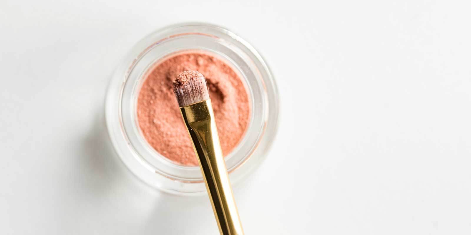 Closeup of a powdery makeup and makeup brush