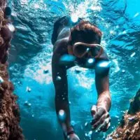 Woman snorkeling amongst coral reef
