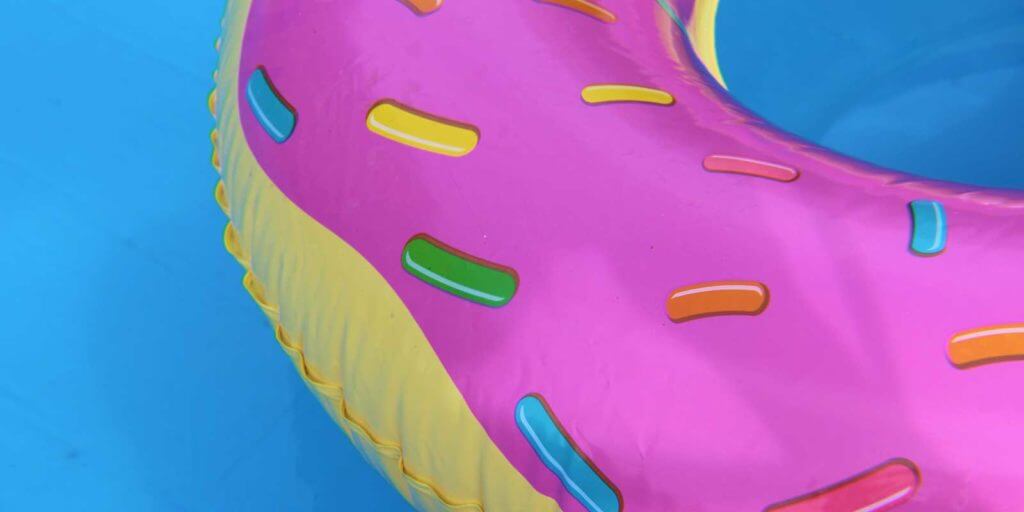 Closeup of a donut pool float in a pool.