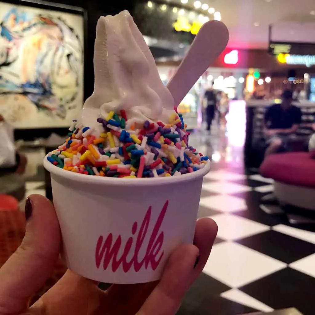 Closeup of a small cup of cereal milk flavored soft serve ice cream with rainbow colored sprinkles from Milk Bar in Las Vegas.
