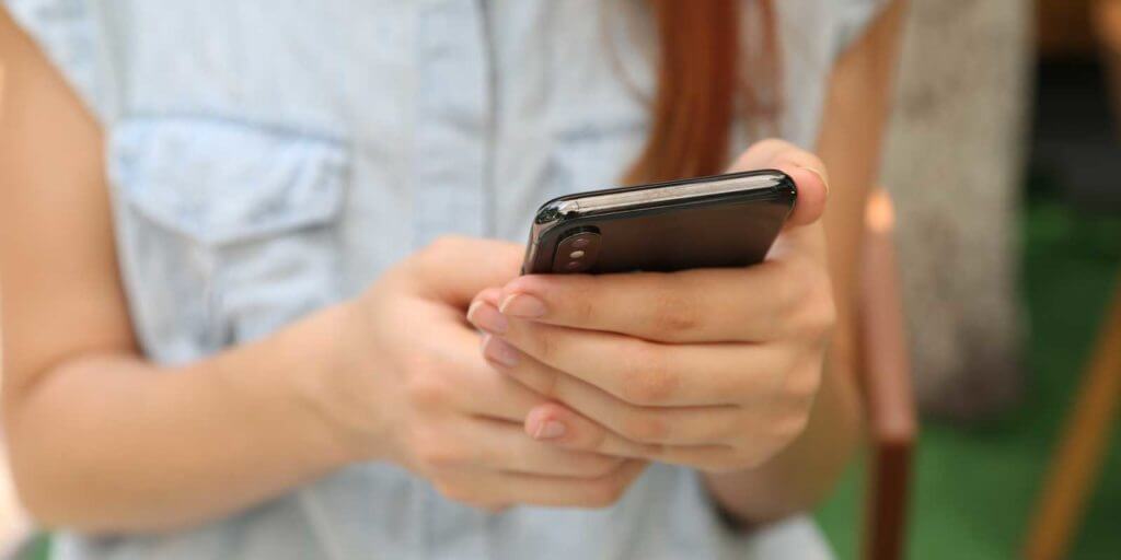 Closeup of woman holding an iPhone.