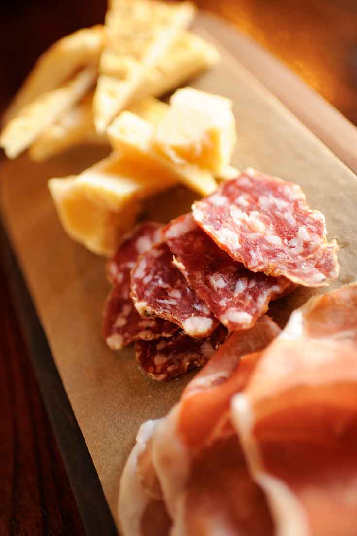 Close up of a meat and cheese platter.