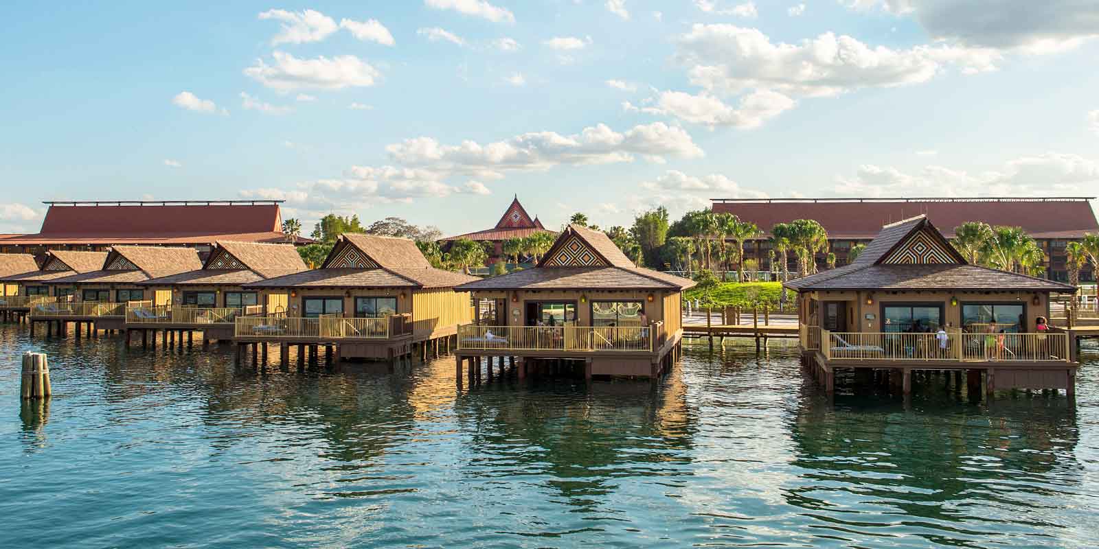 Landscape view of a row of Polynesian-style overwater villas at Disney World.
