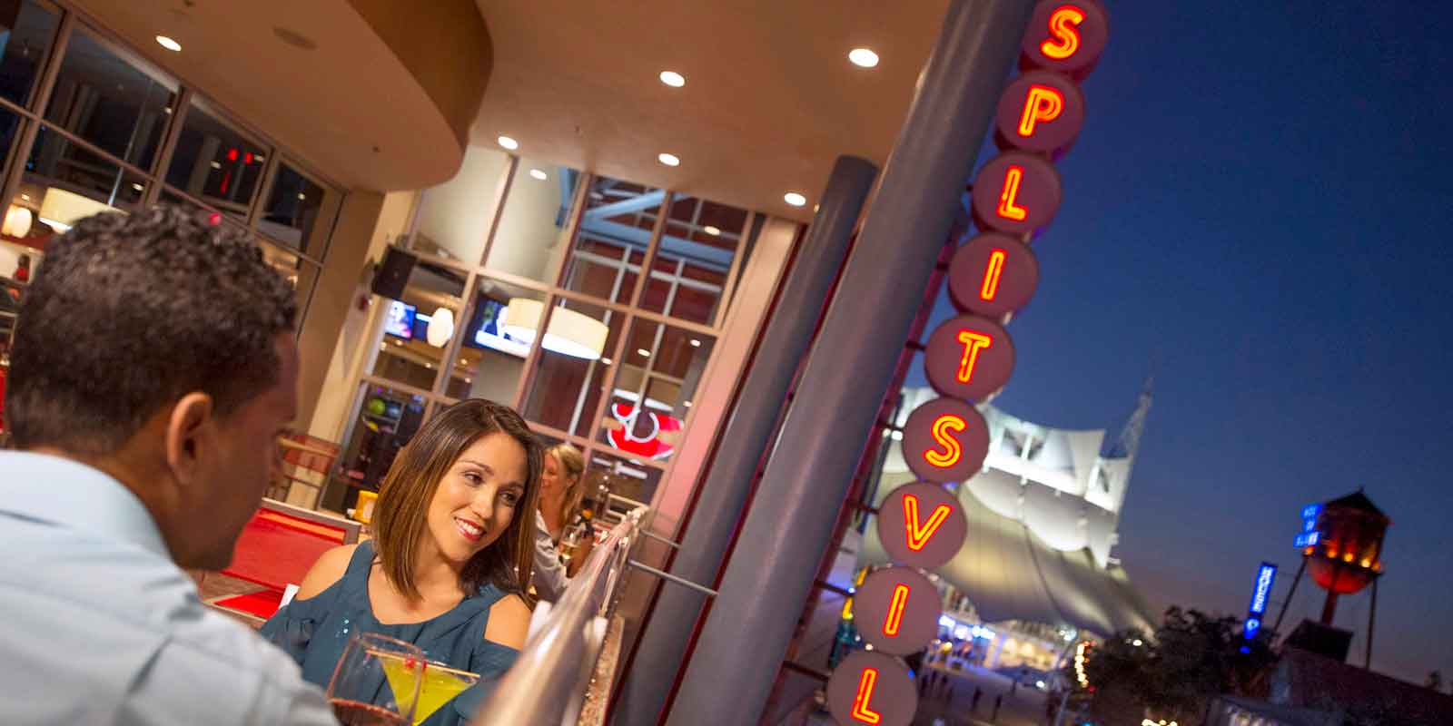 A couple sits on the outdoor deck at Splitsville in Disney Springs.