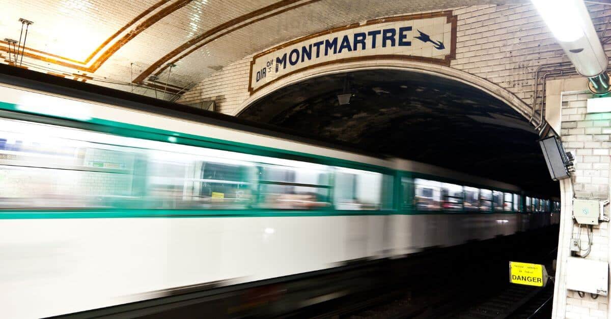Photo of a Paris metro train entering a station near Montmarte.
