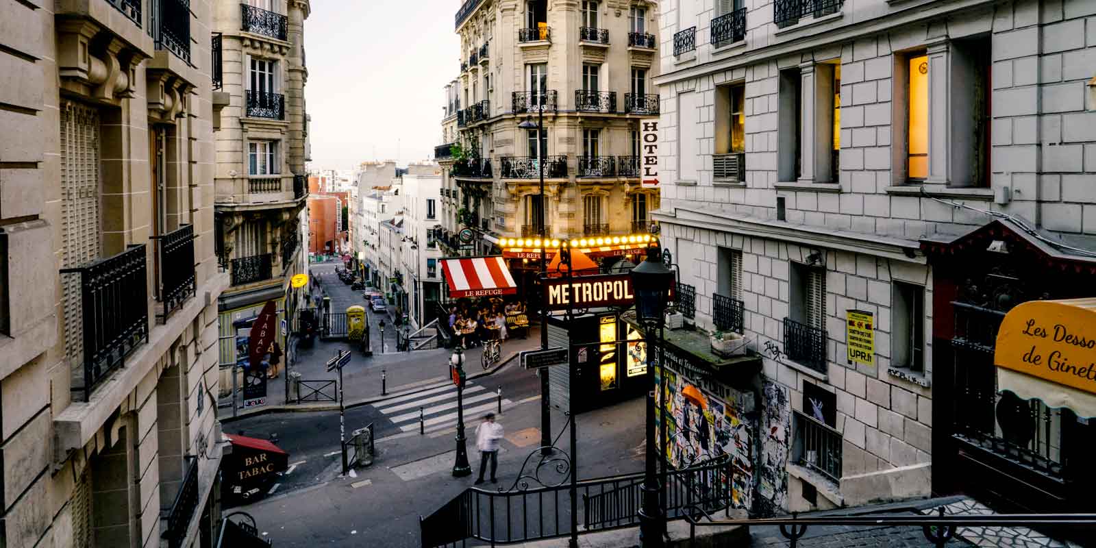 Landscape view of a Parisian neighborhood, with a Metro station, in the background.