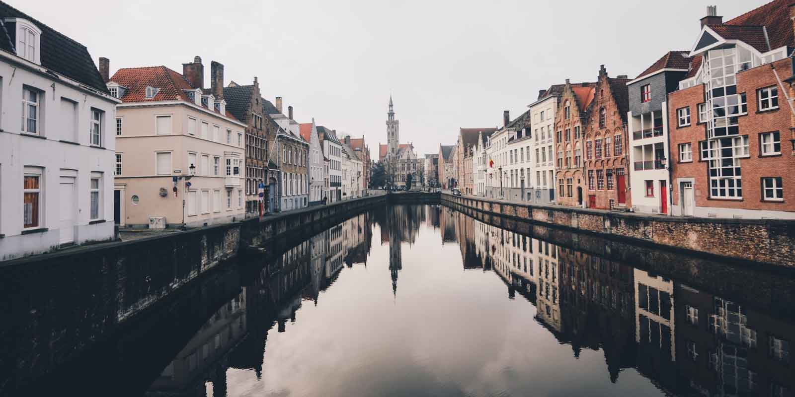 Landscape view of Bruges from the middle of a canal.