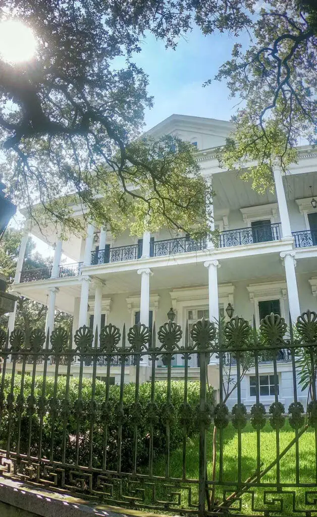 Close up of a white Southern mansion, known as the Buckner Mansion, in New Orleans' Garden District.