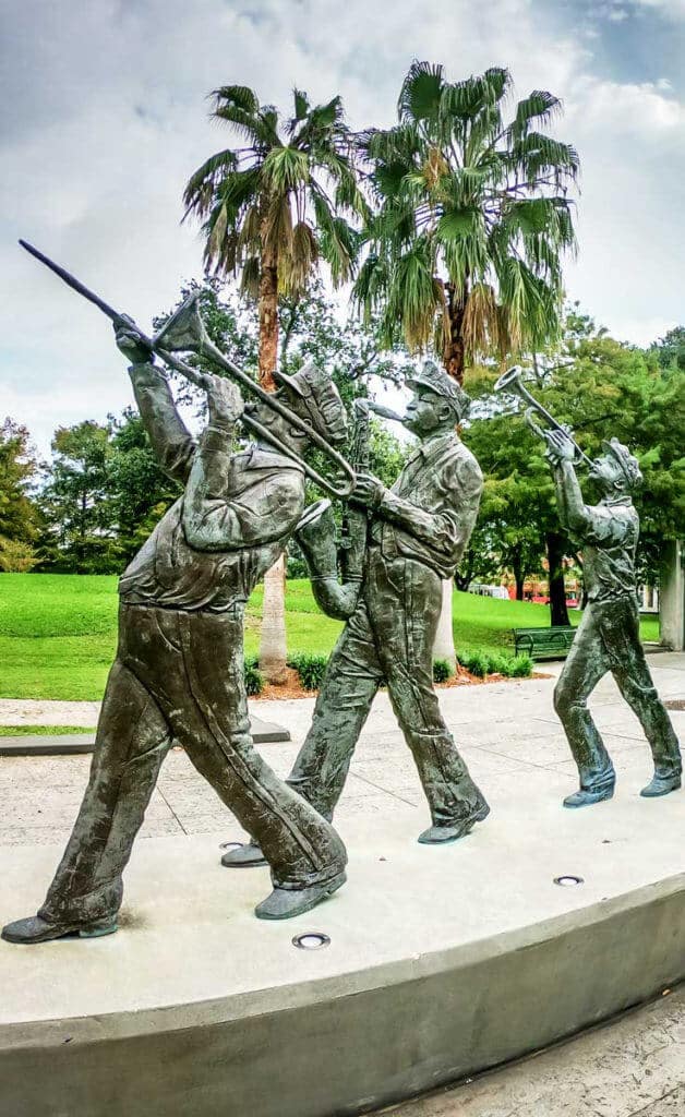 Photo of a statue featuring 3 men playing brass instruments in New Orleans' Louis Armstrong Park