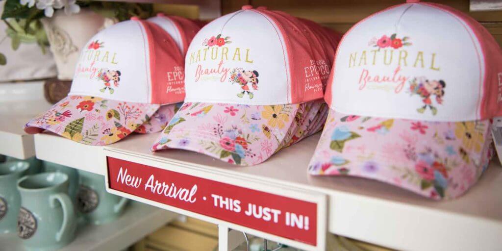 Closeup of a store shelf with Epcot Flower and Garden Festival hats.