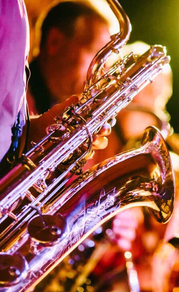 Closeup of a saxophone being played.