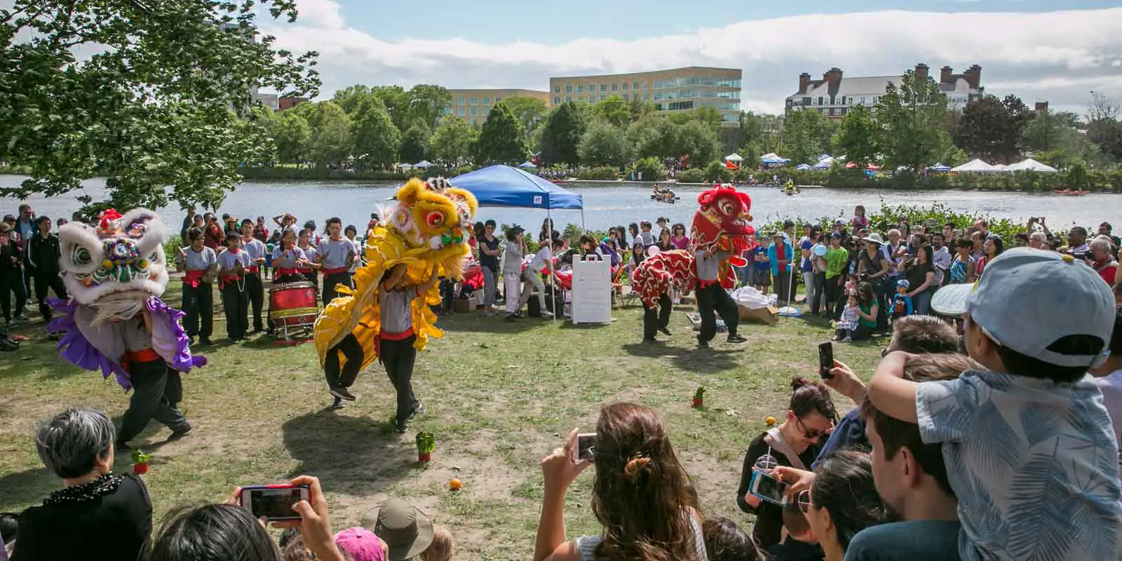 Landscape photo of a Chinese dance performance with colorful dragon costumes at the Boston Dragon Boat Festival.