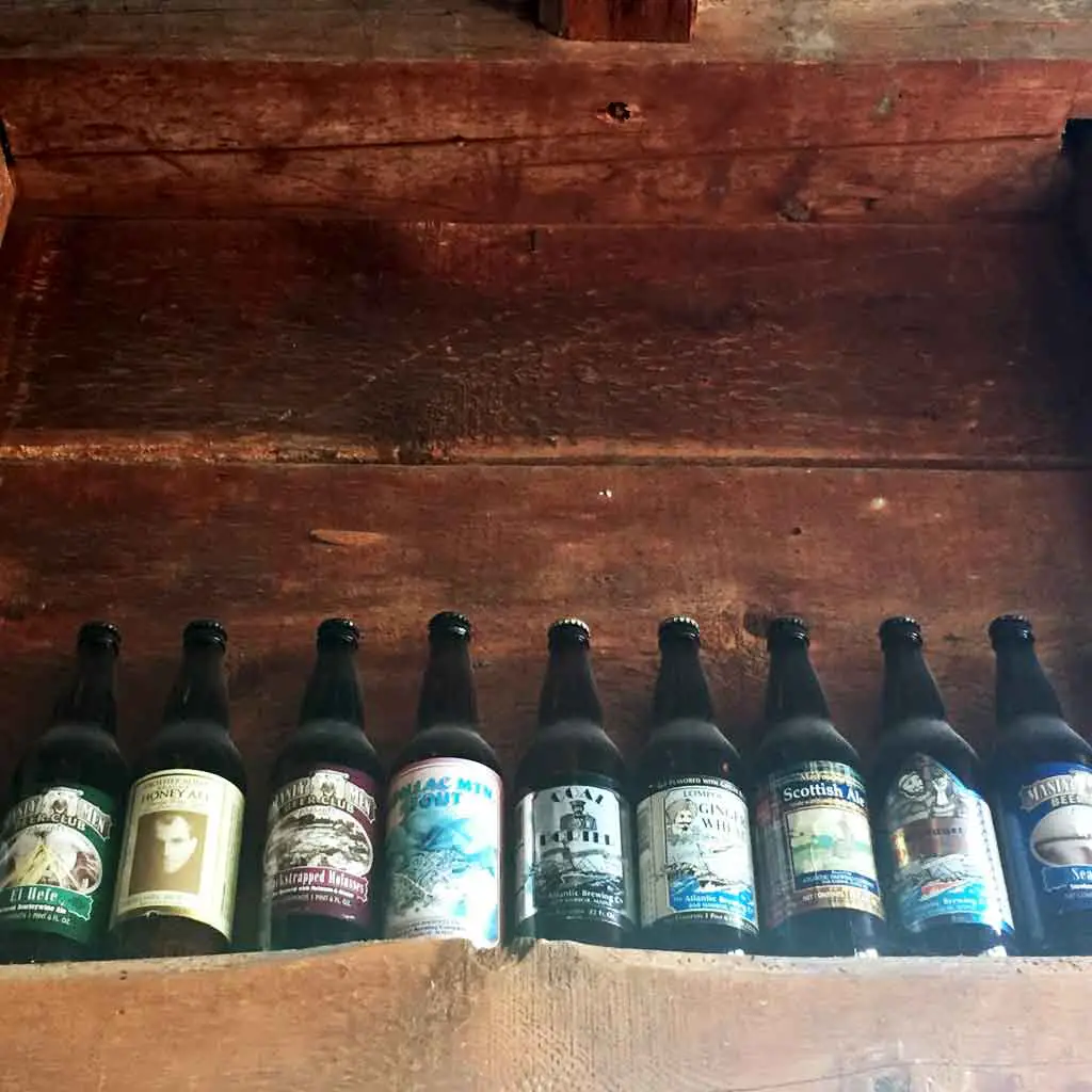 Closeup of beer bottles from Atlantic Brewing Company on a shelf.