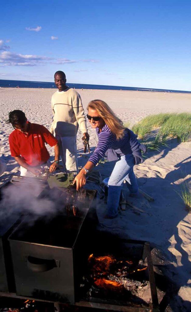 People setting up a clambake on Crane Beach in Ipswich, MA.