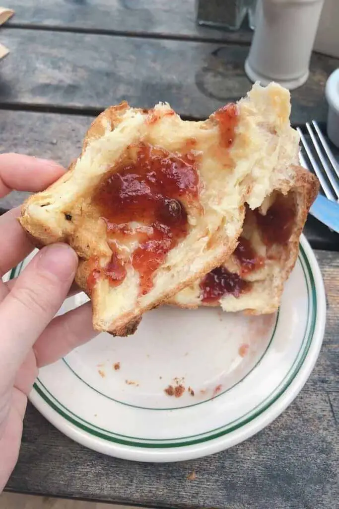 Closeup of an open popover with strawberry jelly in the middle from Jordan Pond House in Bar Harbor, Maine.