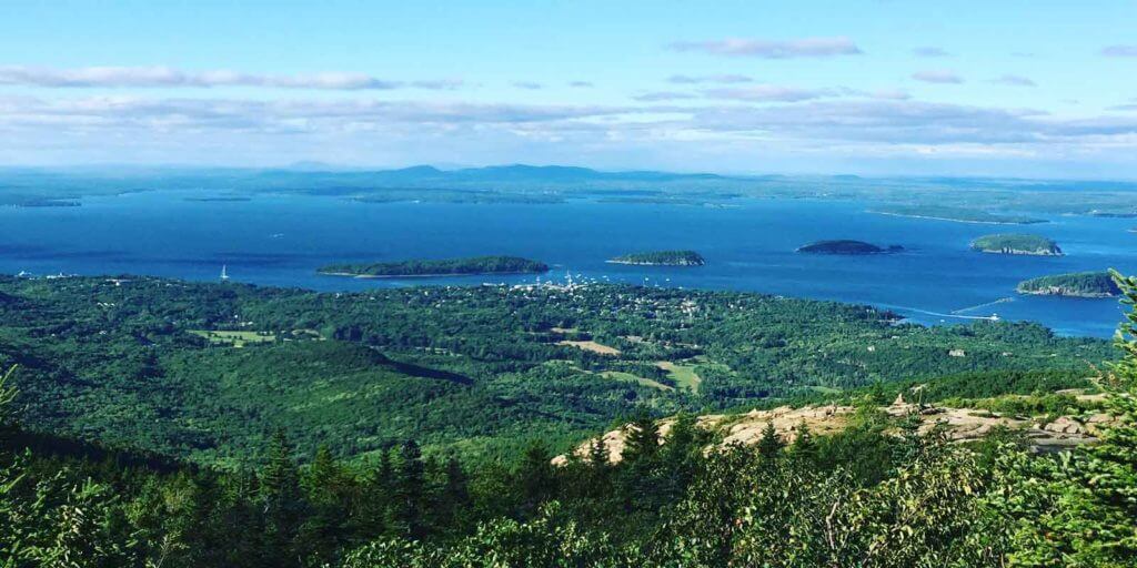 Aerial view of Bar Harbor, Maine and the Atlantic Ocean with several small islands.