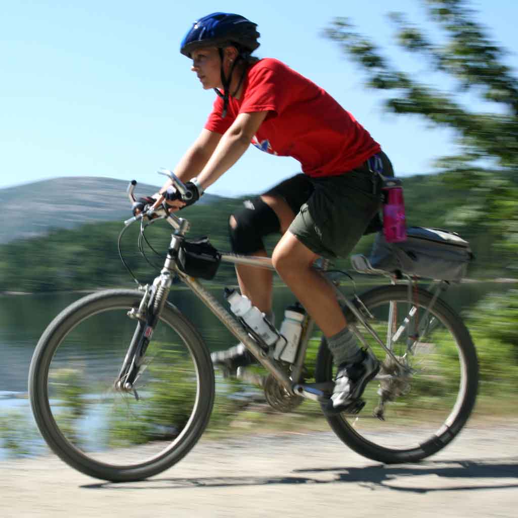 Photo of a man wearing a helmet while riding a mountain bike.