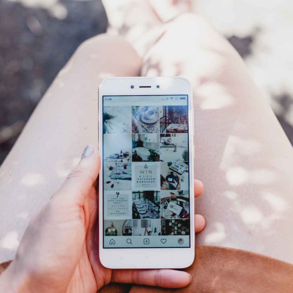 Closeup of a person holding a mobile phone in their lap.