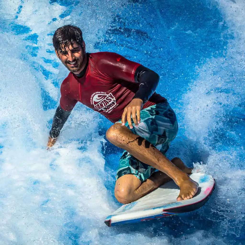 Man on a surfboard in an artificial wave.