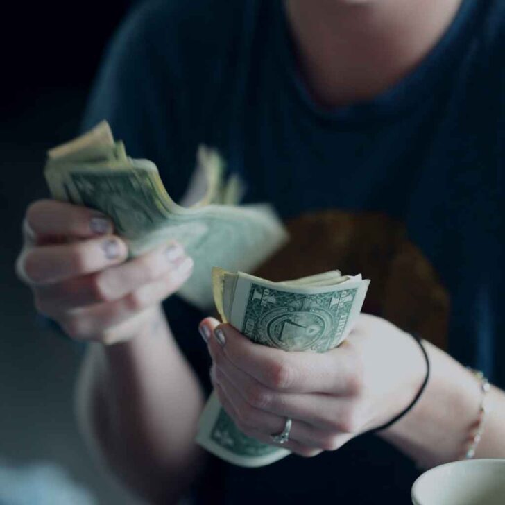 Closeup of a person counting money.