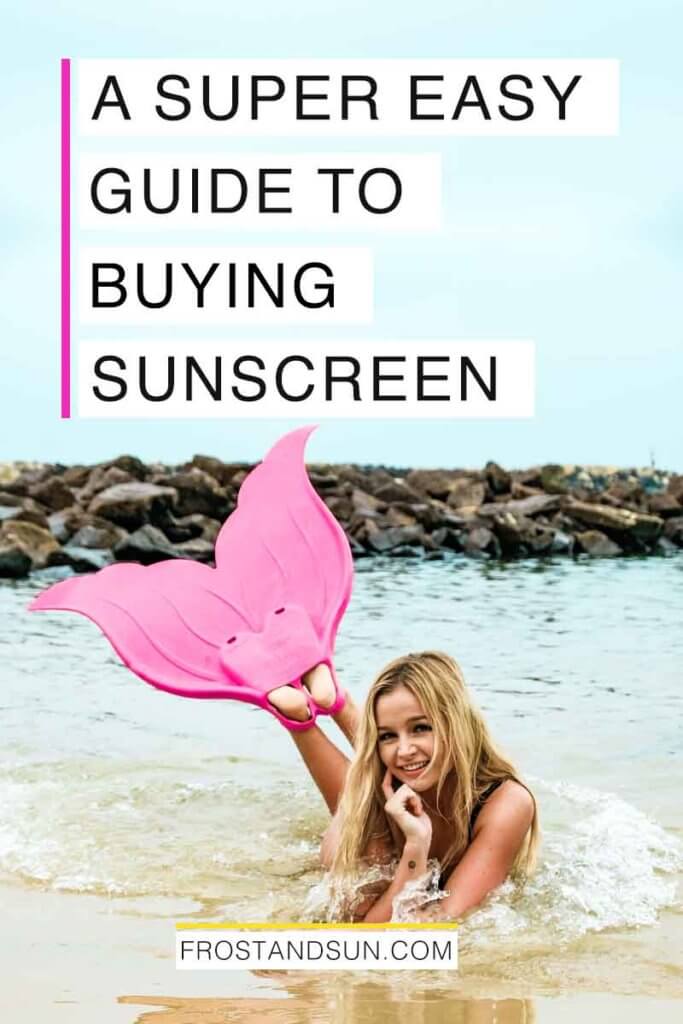 View of a woman laying on her stomach in the ocean wearing rubber mermaid style flippers. Overlying text reads "A Super Easy Guide to Buying Sunscreen."