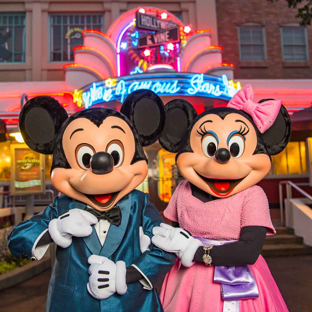 Photo of Mickey and Minnie Mouse in fancy outfits in front of the Hollywood & Vine restaurant.