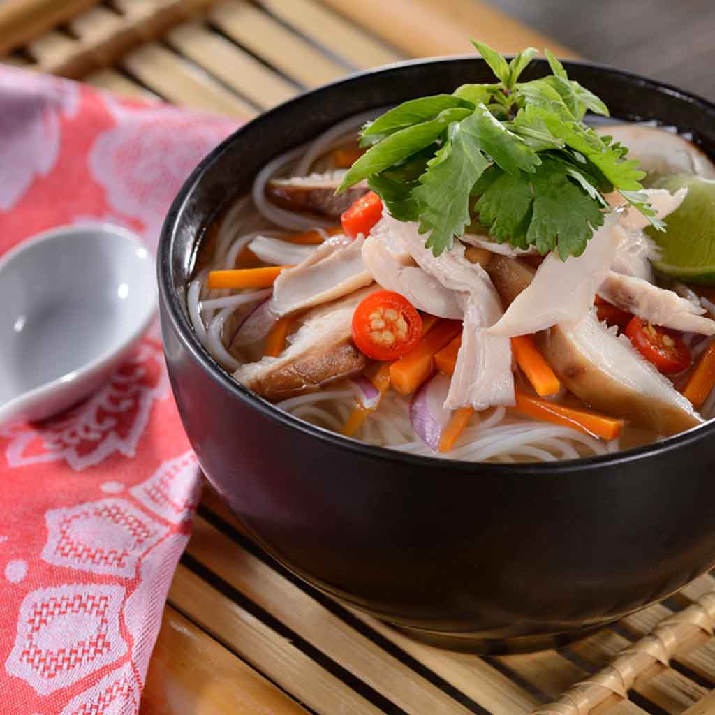 Closeup photograph of a noodle-based soup.