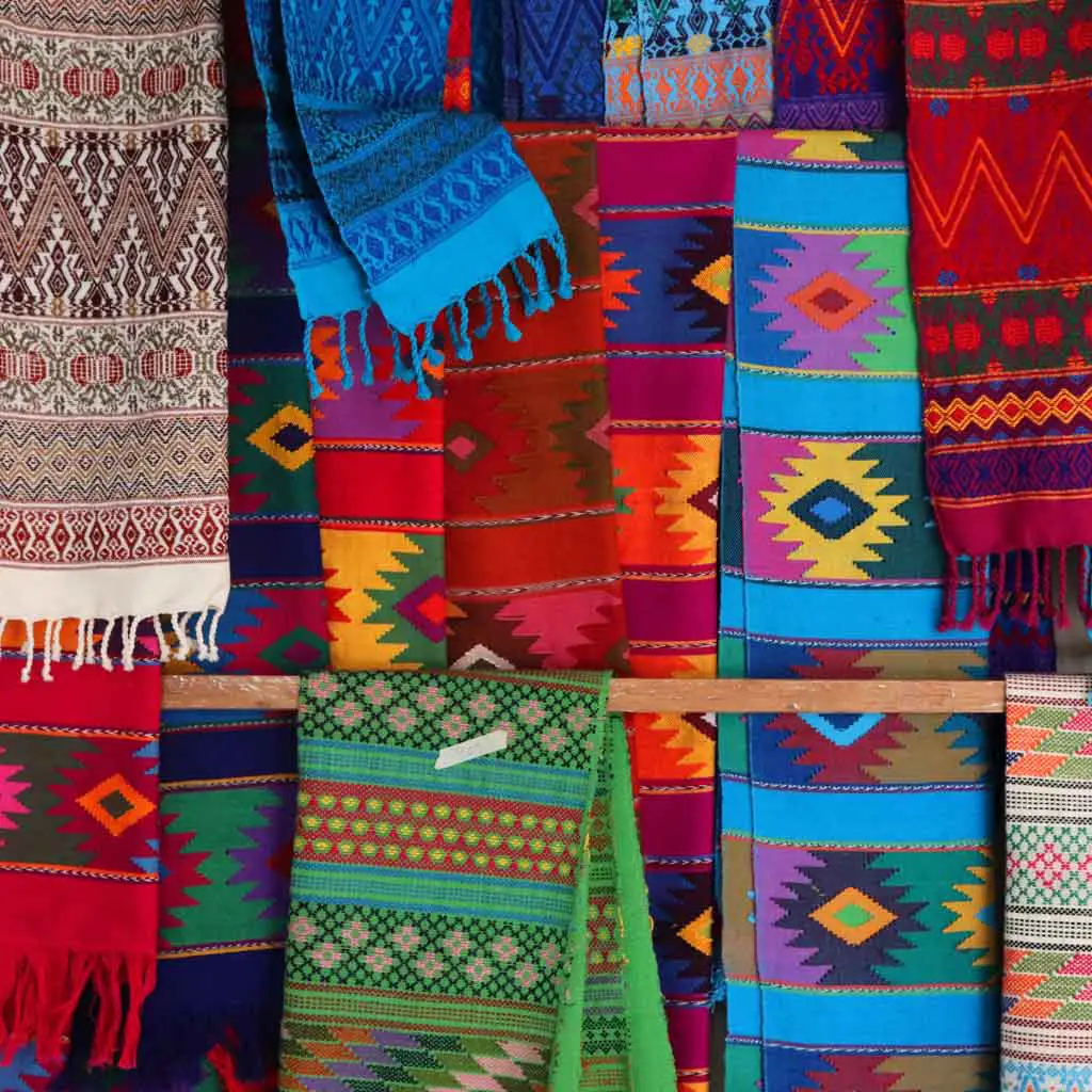 Closeup view of brightly colored textiles with traditional Mexican and Mayan prints.