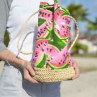 Closeup of a person cradling a large watermelon print tote.
