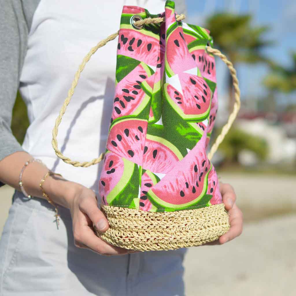 Closeup of a person cradling a large watermelon print tote.