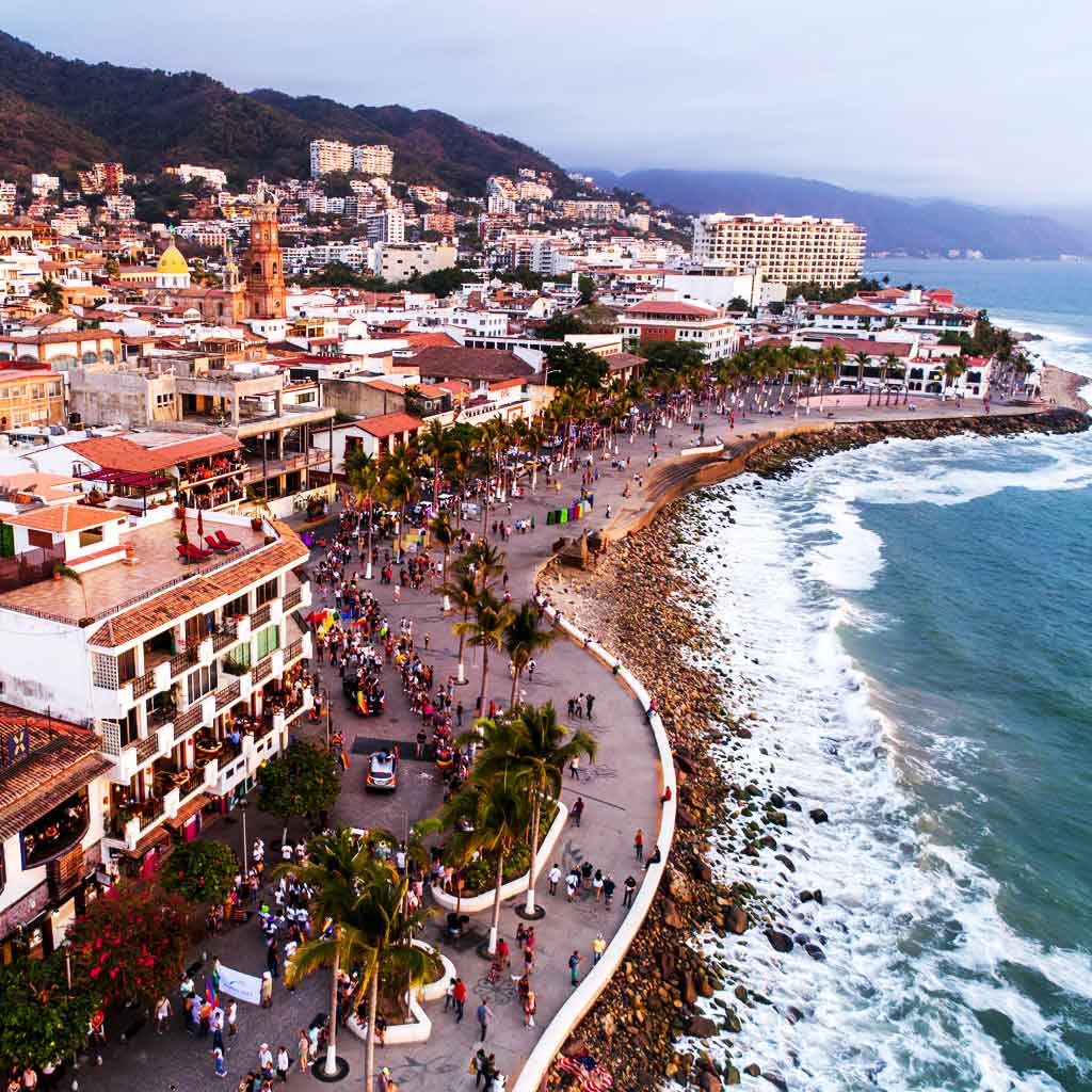 Aerial view of a booming town set along the ocean.