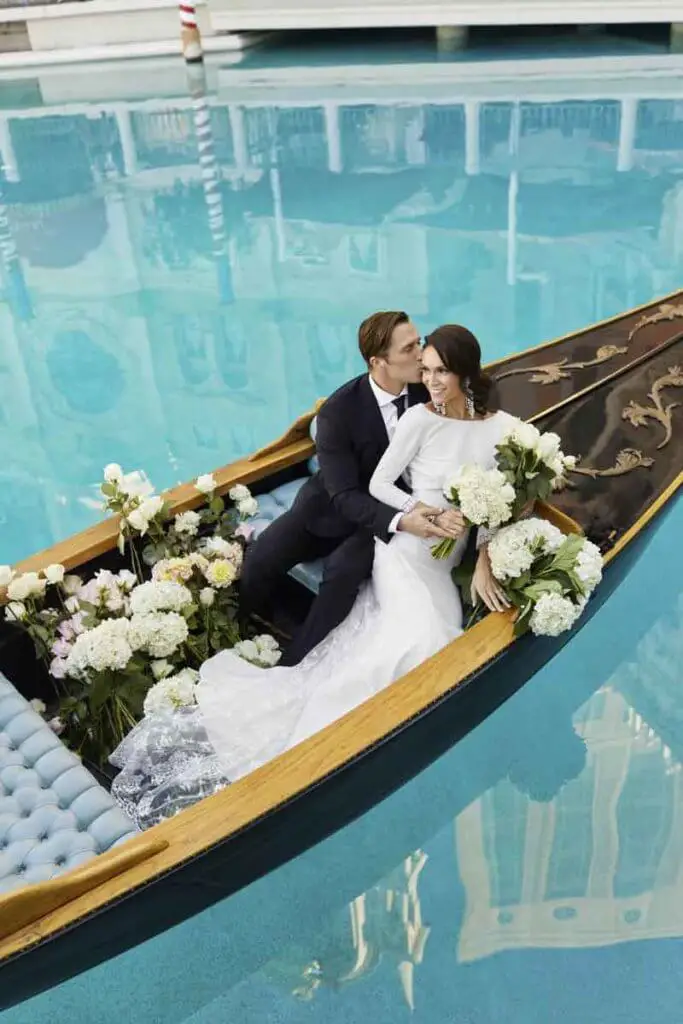 Closeup of a bride and groom posing in a gondola.