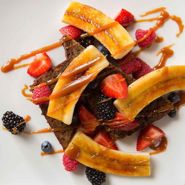 Photo of a plate of banana french toast with berries.