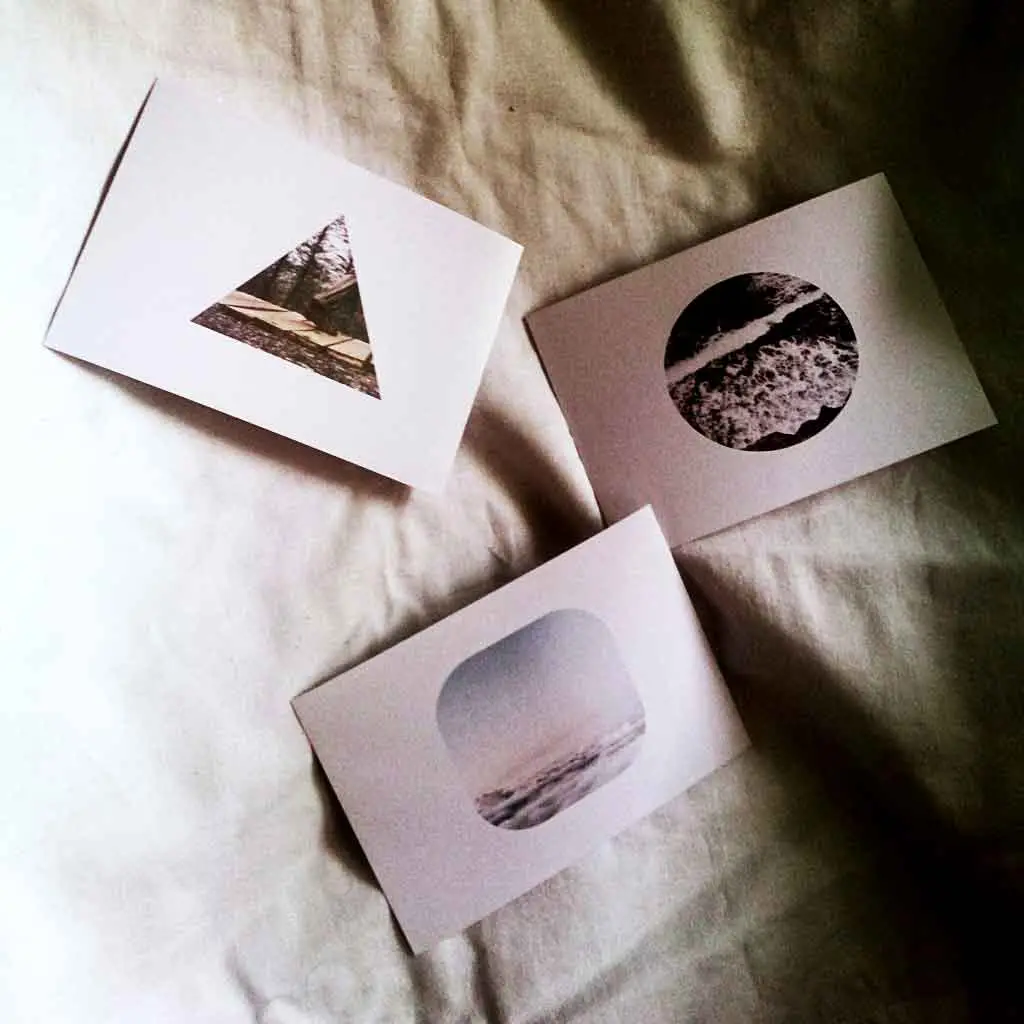 Picture of 3 greeting cards with pictures printed on them.
