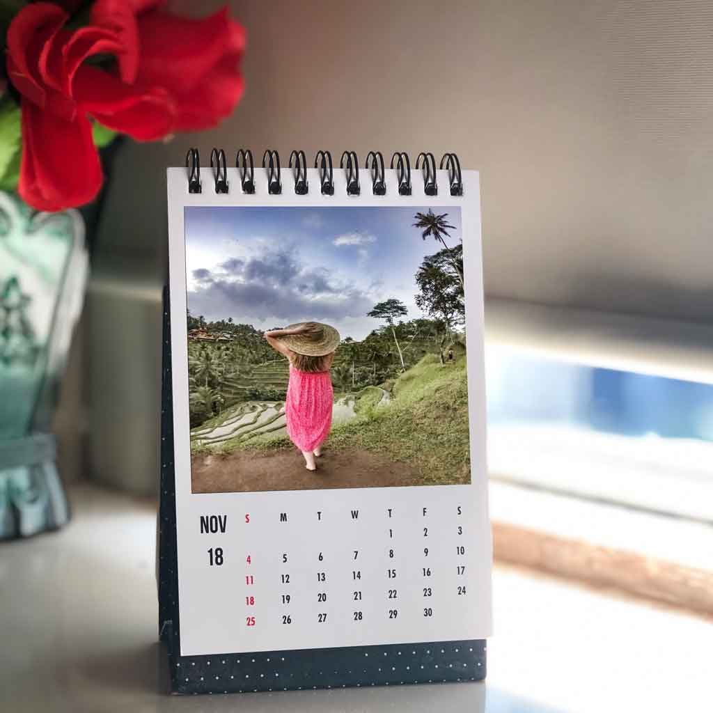 Closeup of a small desk calendar with a personalized photo.