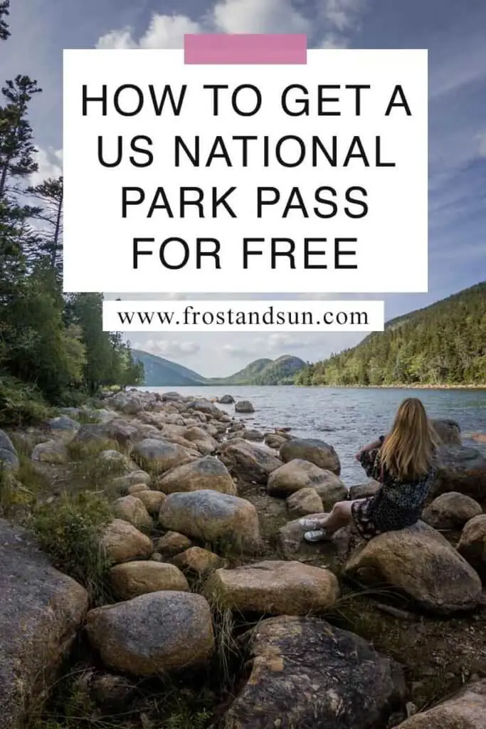 Photo of a woman sitting on a rocky shoreline overlooking a lake with mountains in the background. Overlying text reads "How to Get a US National Park Pass for Free"