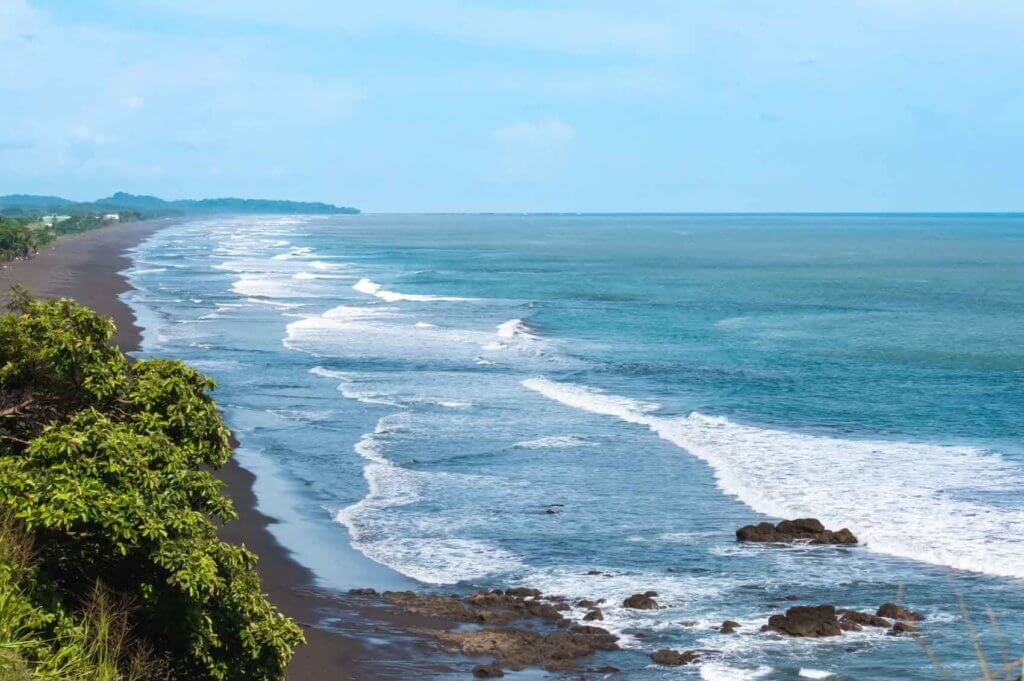 Aerial landscape view of a black sand beach in Costa Rica.